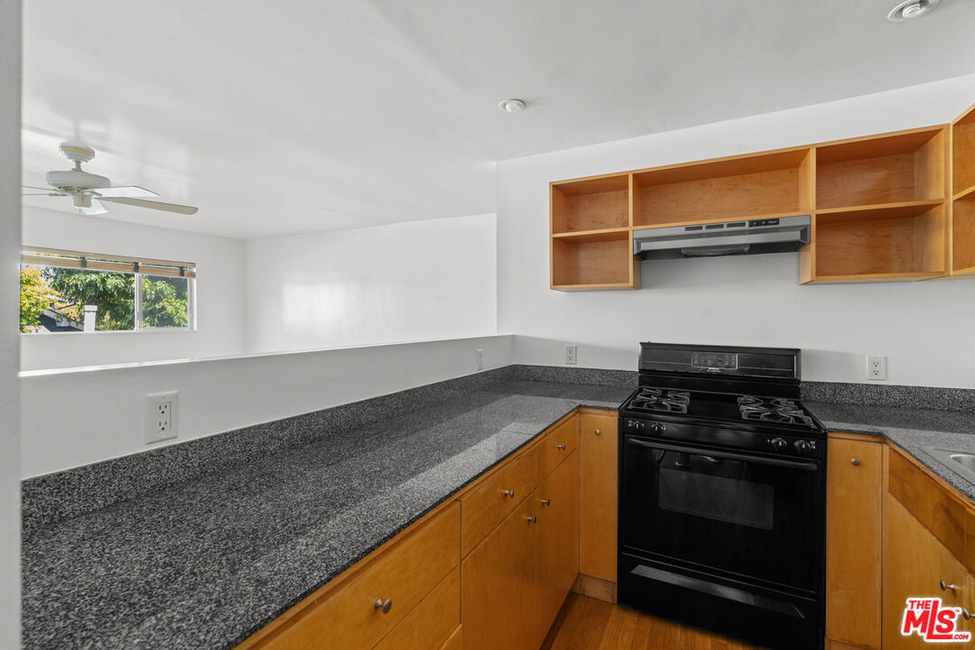511 Rialto Avenue, Unit 4 Venice, CA 90291 - Photo 10 of 17 a kitchen with granite countertop stainless steel appliances a stove a sink and a microwave