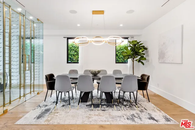 a very nice looking room with a large window and chairs