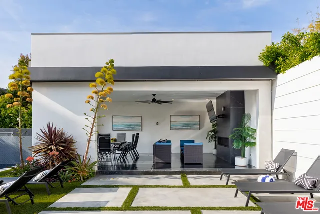 a view of a house with swimming pool and furniture