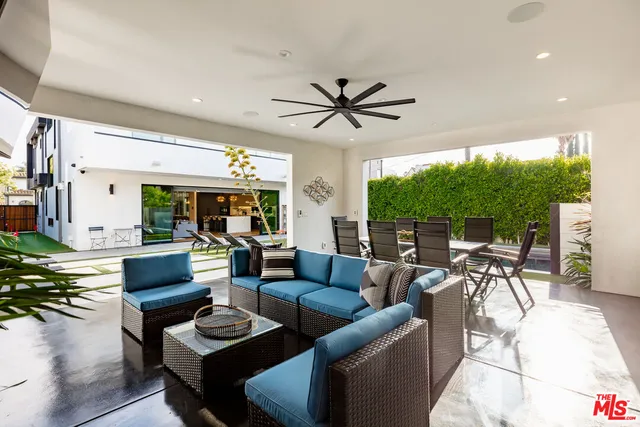 a swimming pool view with a outdoor seating space