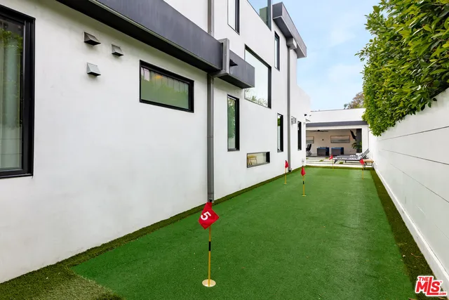 a view of a house with couches chairs and a yard
