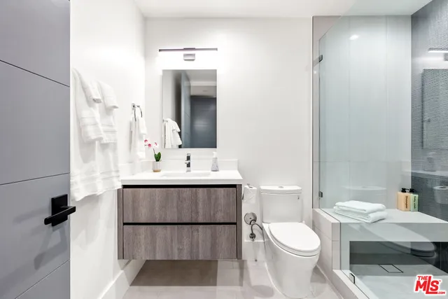 a bedroom with a bed and a chair