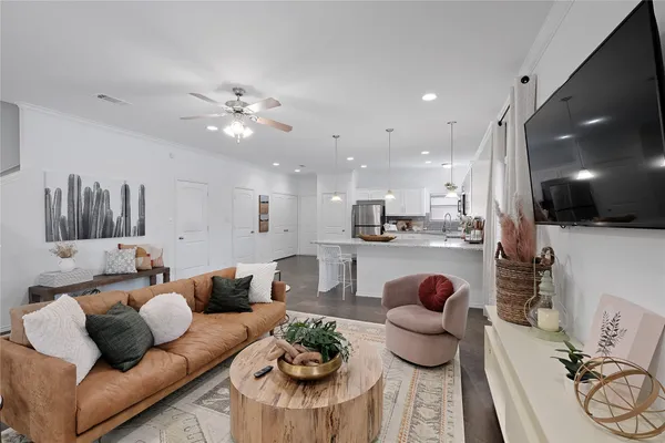 a living room with furniture and wooden floor