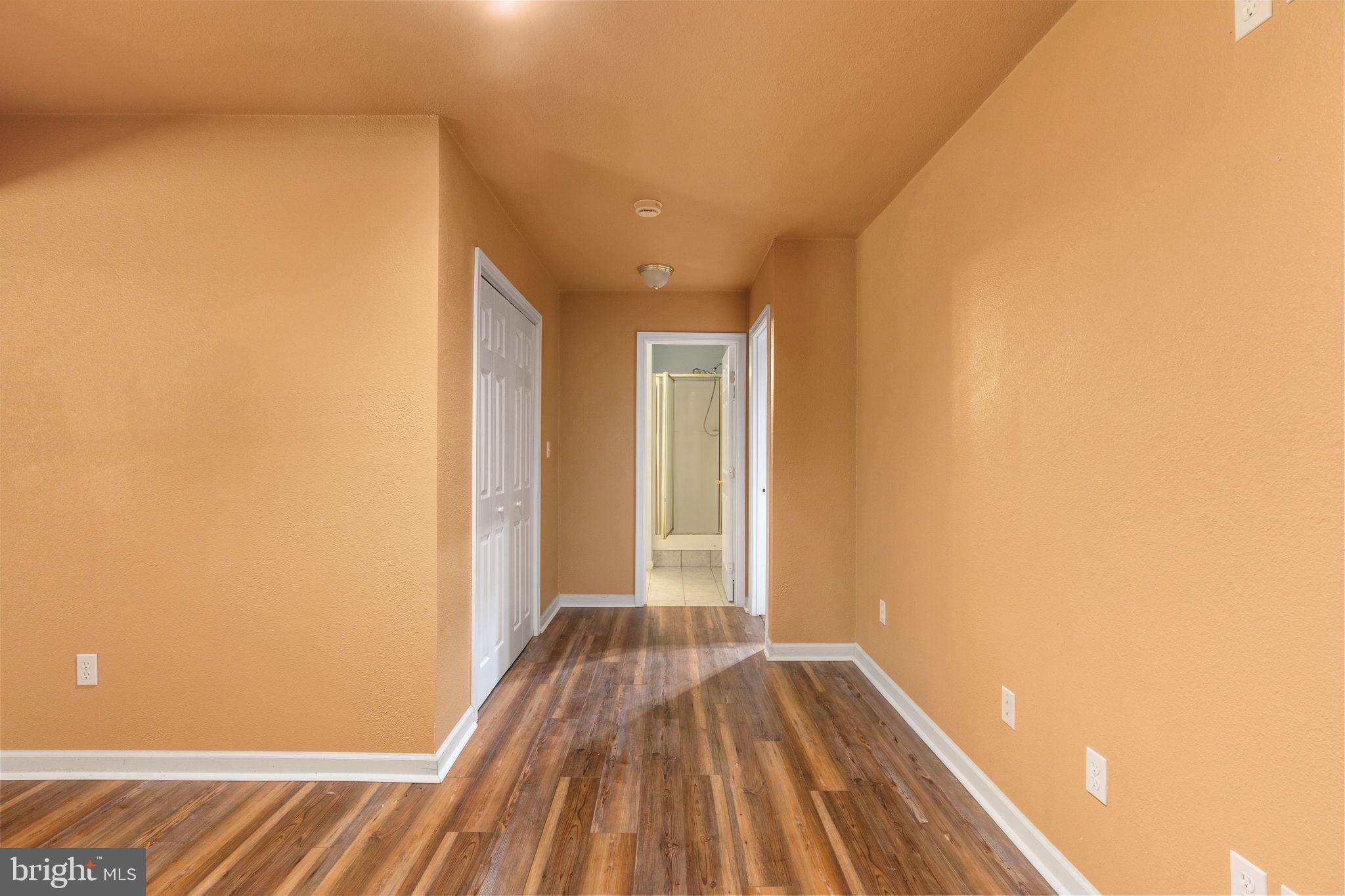 8009 Burrell Road Fredericksburg, VA 22407 - Photo 31 of 66 Inviting hallway with warm tones.