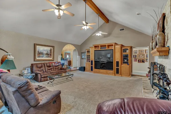a living room with furniture a fireplace and a chandelier