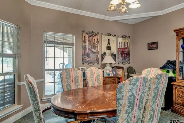 a large kitchen with a table and chairs