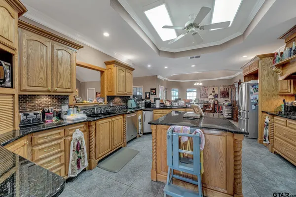a kitchen with stainless steel appliances granite countertop a sink stove and cabinets