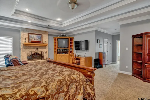 a bedroom with furniture and a flat screen tv