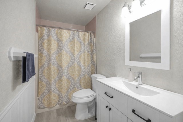 29206 Stapleford Street Spring, TX 77386 - Photo 11 of 22 a bathroom with a toilet a sink and a mirror