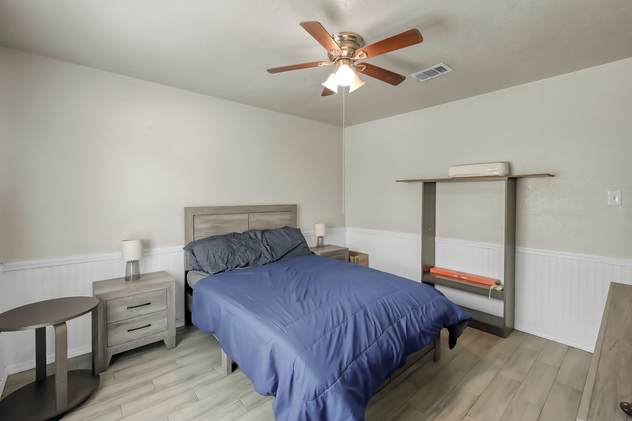 29206 Stapleford Street Spring, TX 77386 - Photo 13 of 22 a bedroom with a large bed and a chandelier