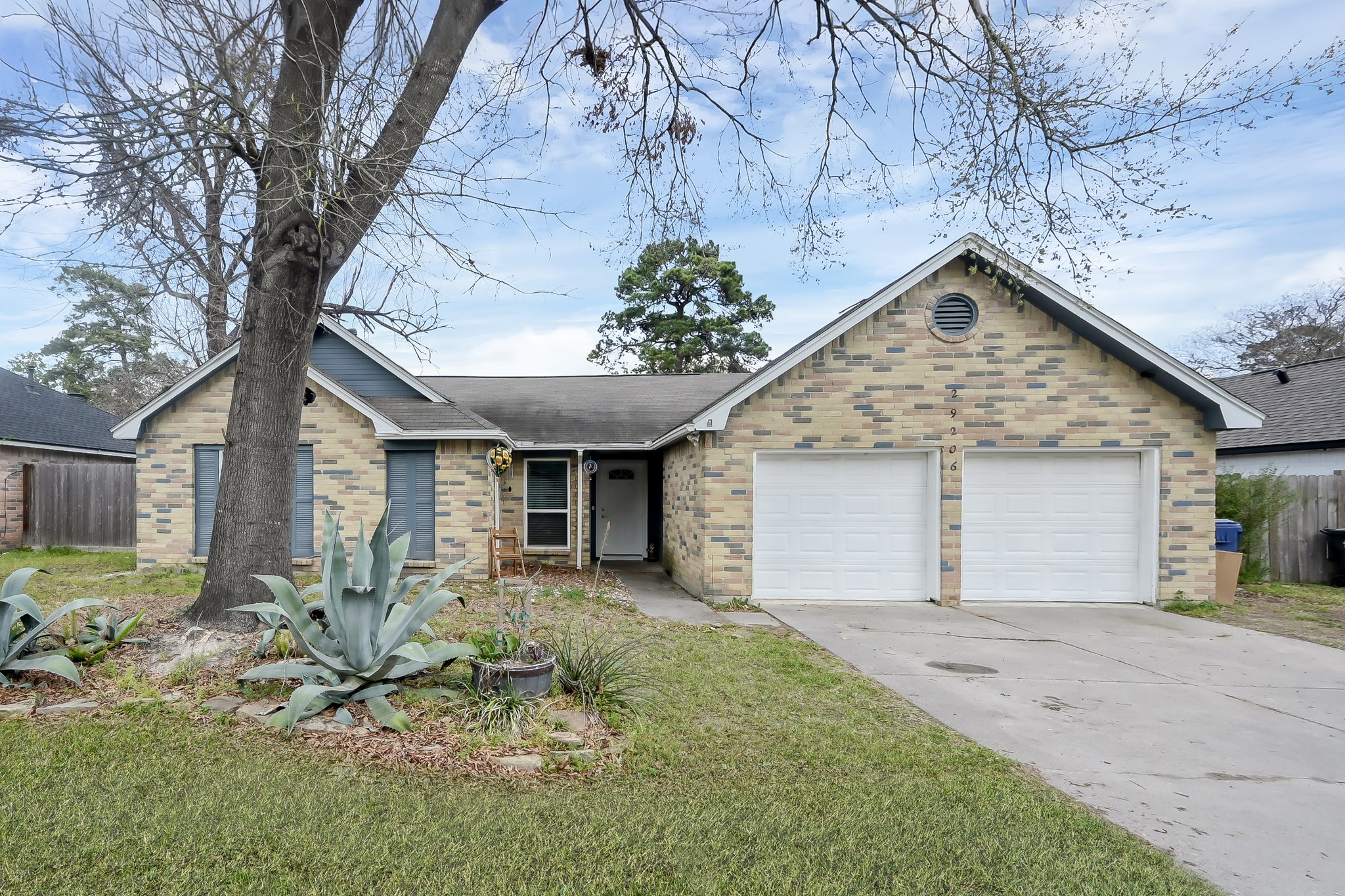 29206 Stapleford Street Spring, TX 77386 - Photo 3 of 22 a front view of a house with a yard and potted plants