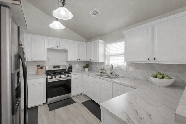 29206 Stapleford Street Spring, TX 77386 - Photo 9 of 22 a kitchen with stainless steel appliances a sink stove and refrigerator