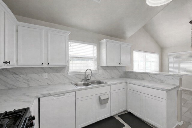 29206 Stapleford Street Spring, TX 77386 - Photo 10 of 22 a kitchen with white cabinets appliances a sink and a window