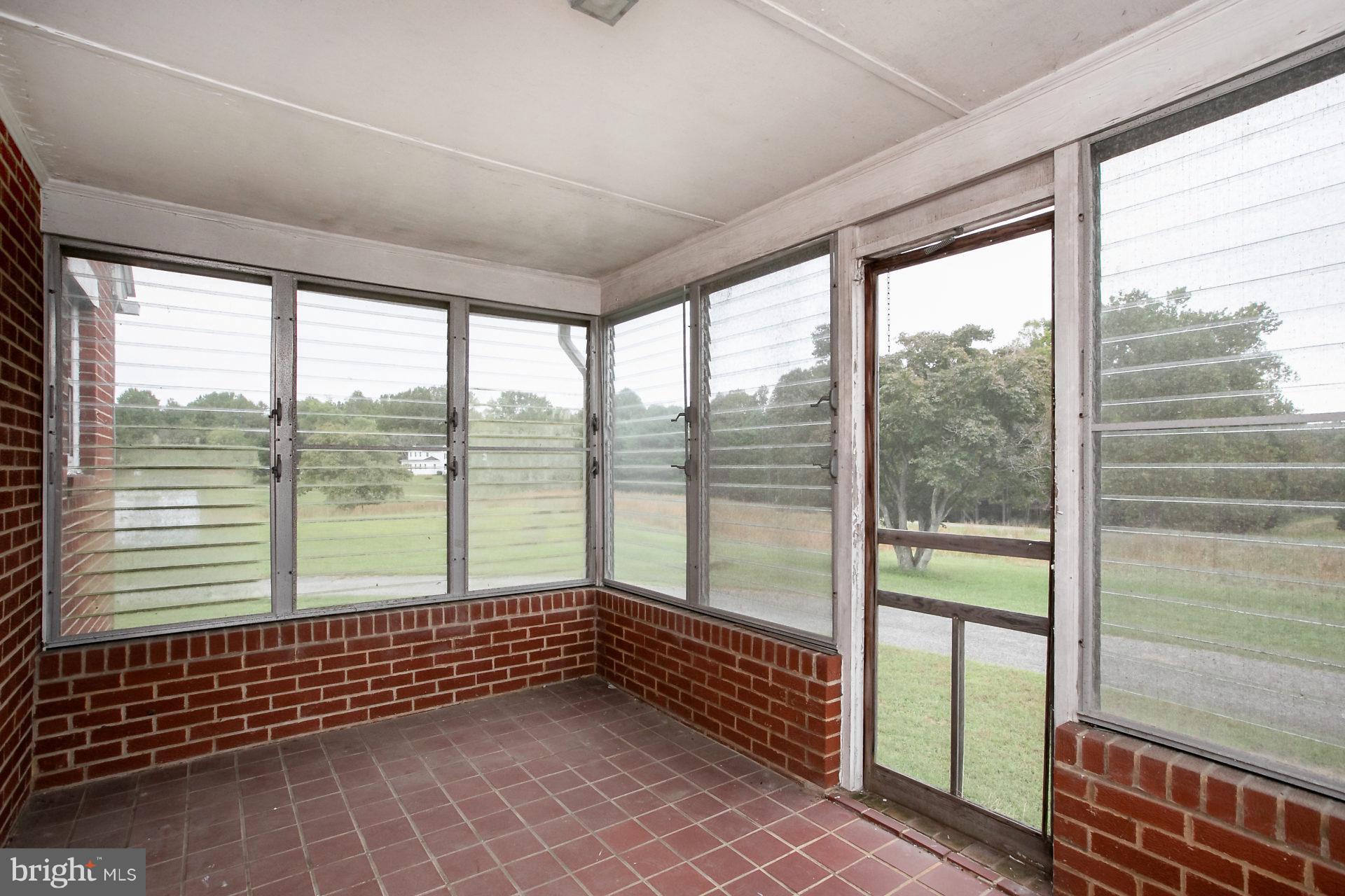 2815 Holland Cliffs Road Huntingtown, MD 20639 - Photo 17 of 21 All weather enclosed side porch w/louvered windows