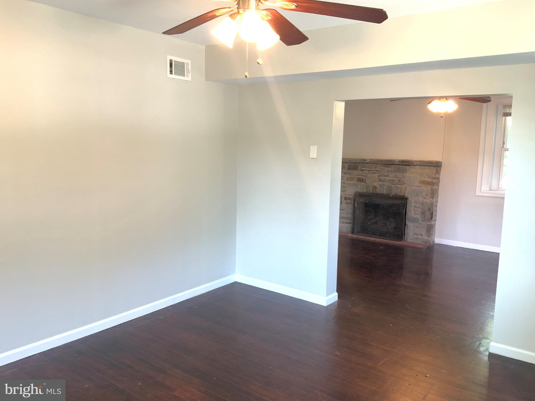 6209 York Road, Unit A Baltimore, MD 21212 - Photo 12 of 31 an empty room with wooden floor fireplace and windows