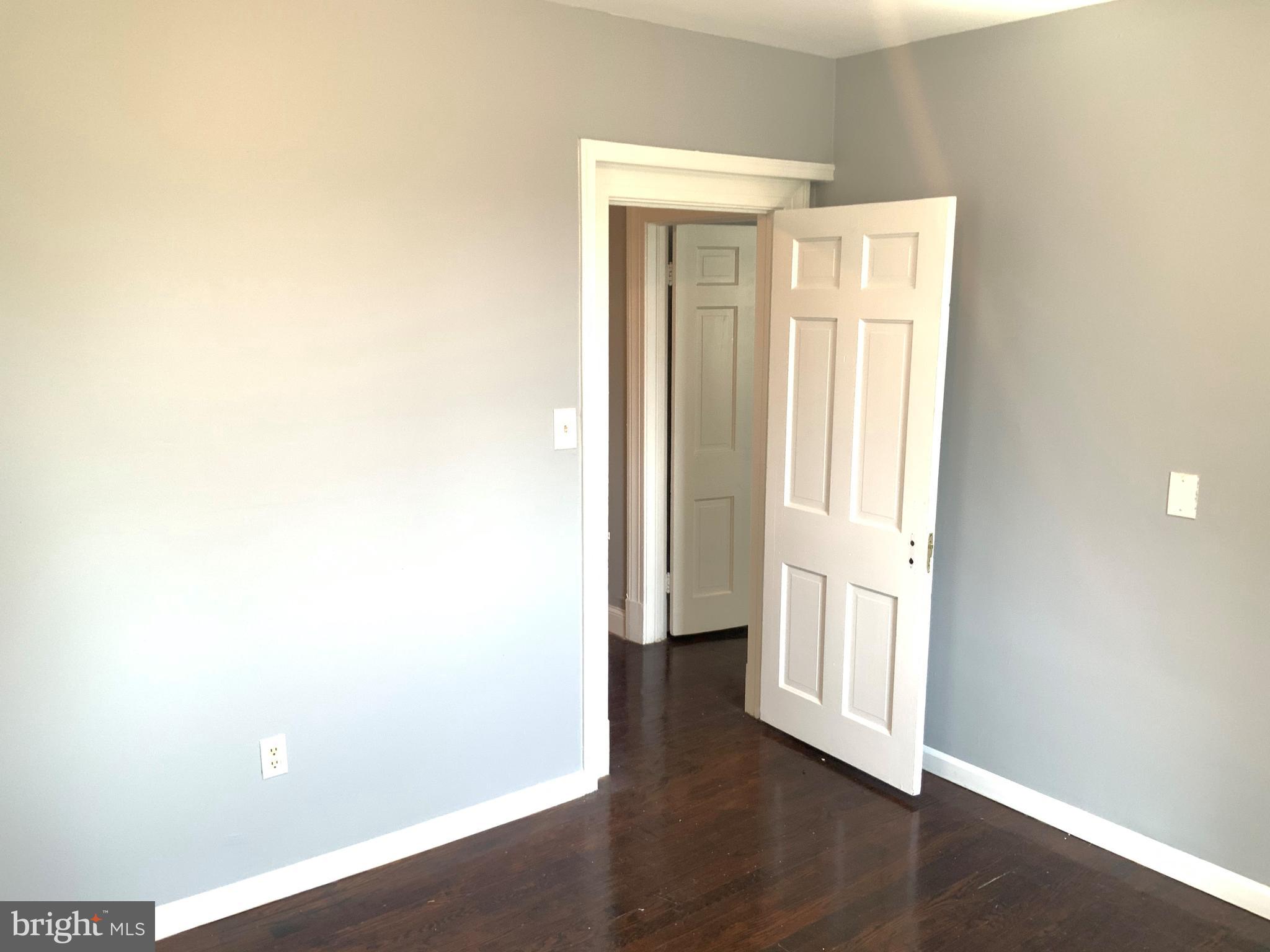 6209 York Road, Unit A Baltimore, MD 21212 - Photo 17 of 31 an empty room with wooden floor and windows