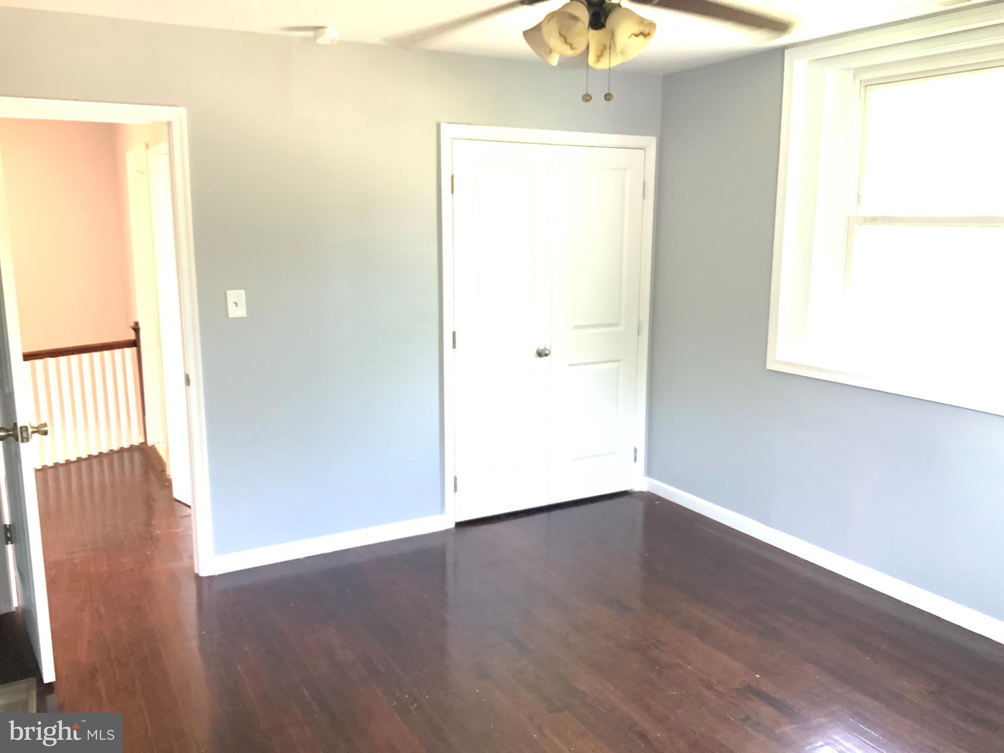 6209 York Road, Unit A Baltimore, MD 21212 - Photo 23 of 31 an empty room with wooden floor and windows