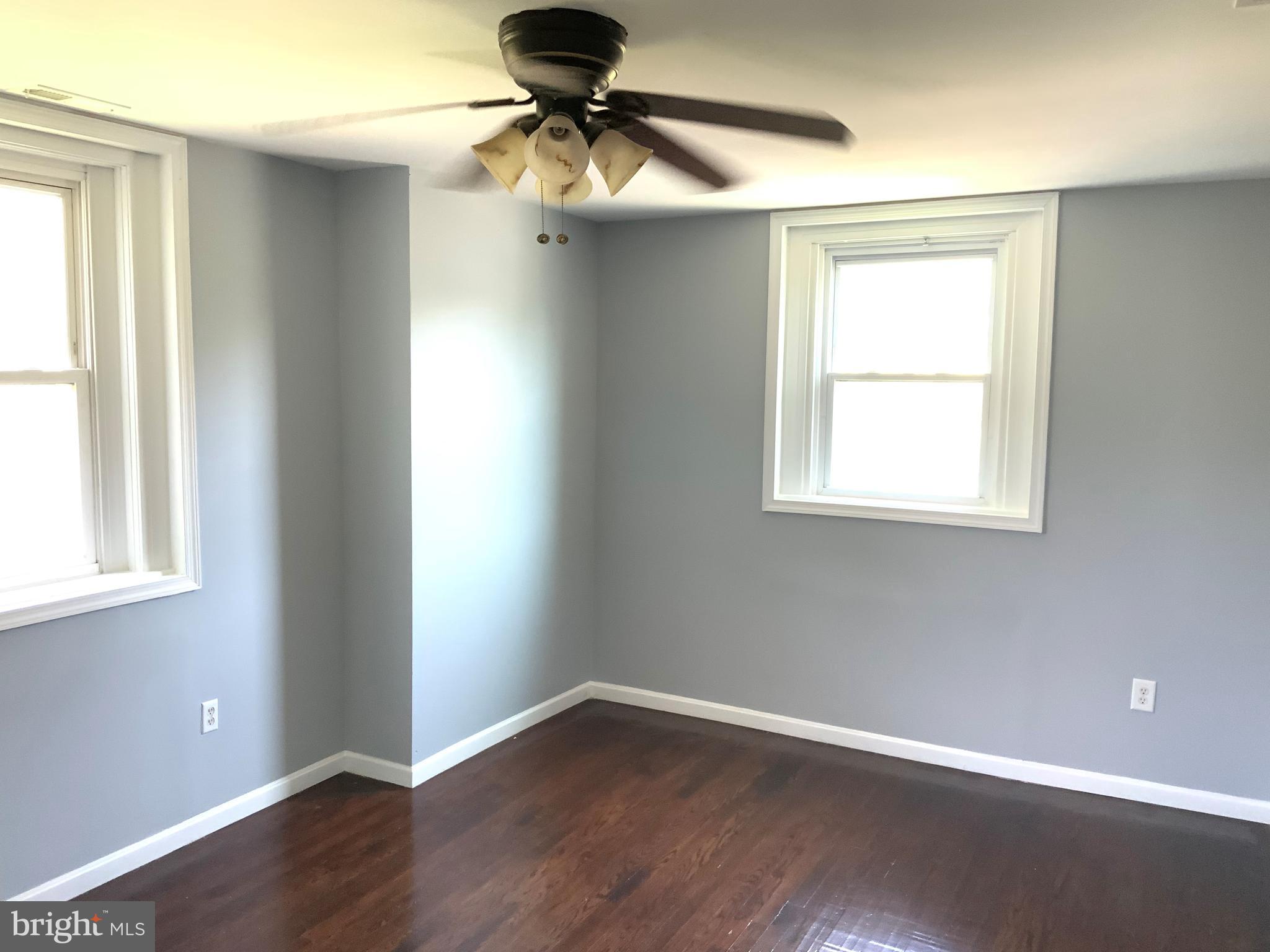 6209 York Road, Unit A Baltimore, MD 21212 - Photo 24 of 31 wooden floor in an empty room with a window
