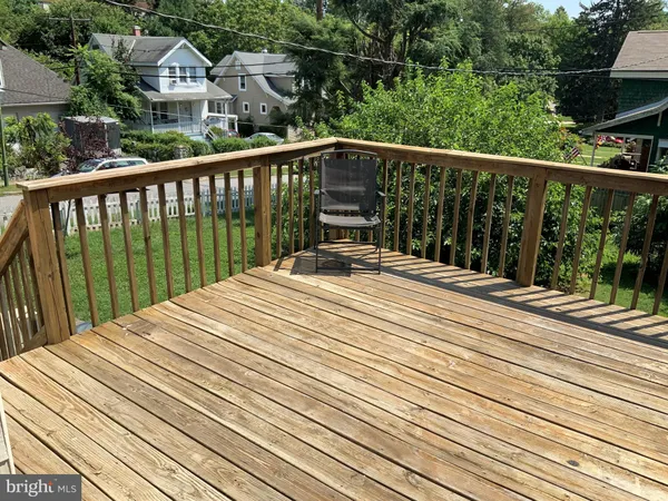 a view of balcony with wooden floor and fence