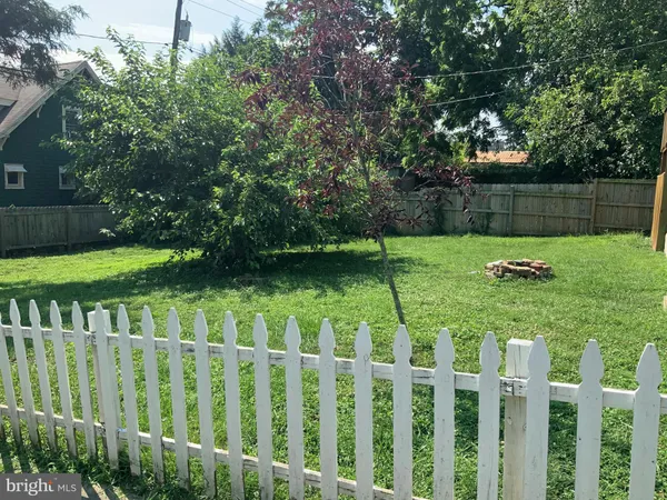 a view of a backyard with a fence