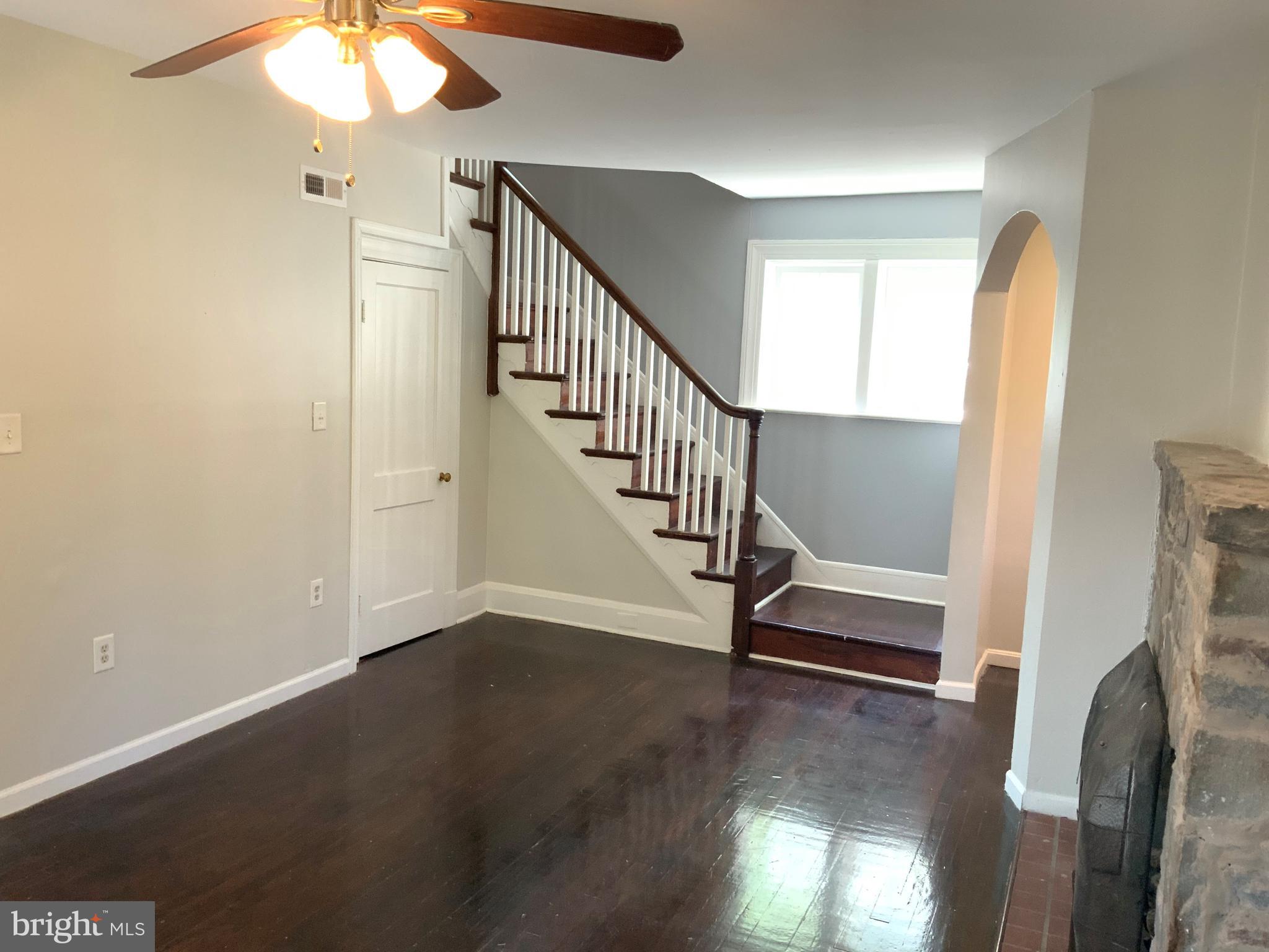 6209 York Road, Unit A Baltimore, MD 21212 - Photo 4 of 31 a view of a livingroom with wooden floor and a staircase