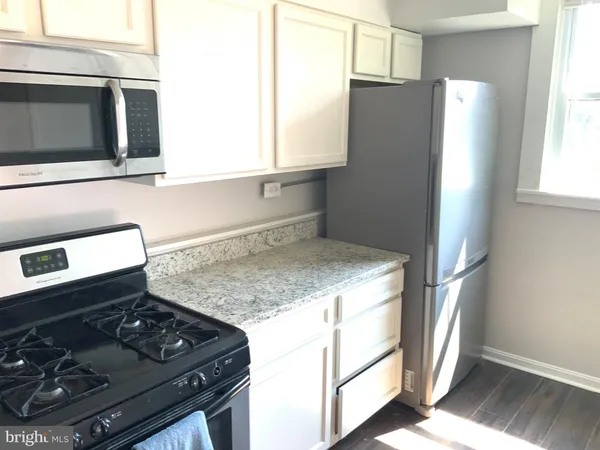 a kitchen with a stove and a microwave