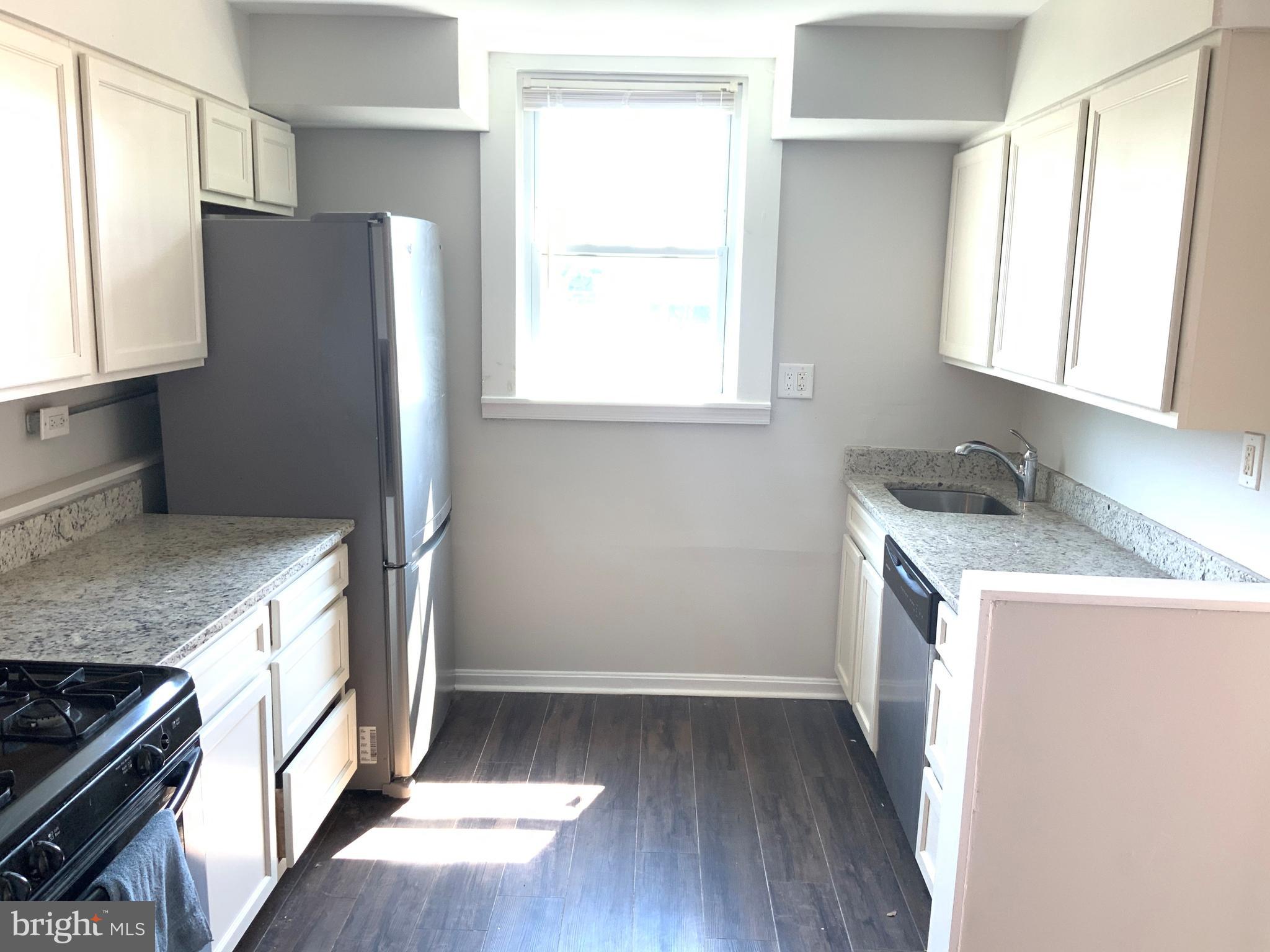 6209 York Road, Unit A Baltimore, MD 21212 - Photo 9 of 31 a kitchen with granite countertop a refrigerator and a sink