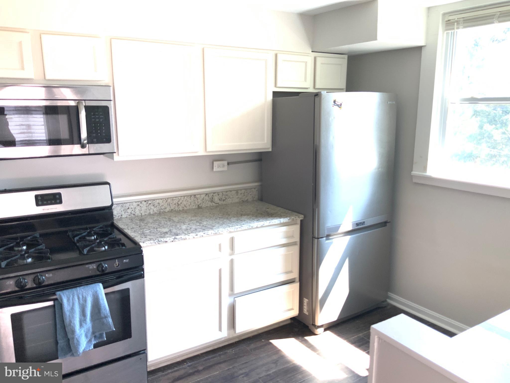6209 York Road, Unit A Baltimore, MD 21212 - Photo 10 of 31 a kitchen with a refrigerator stove and microwave