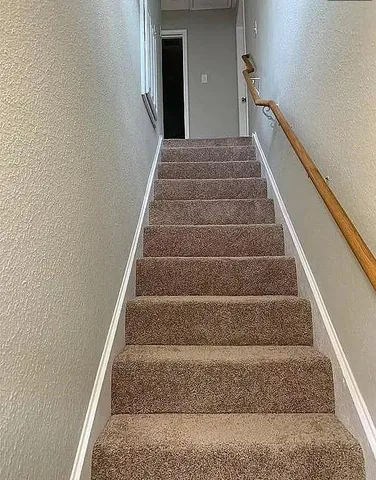 an empty room with wooden floor and entrance