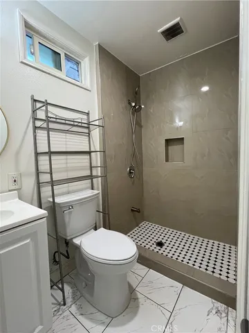 a bathroom with a toilet a sink and shower