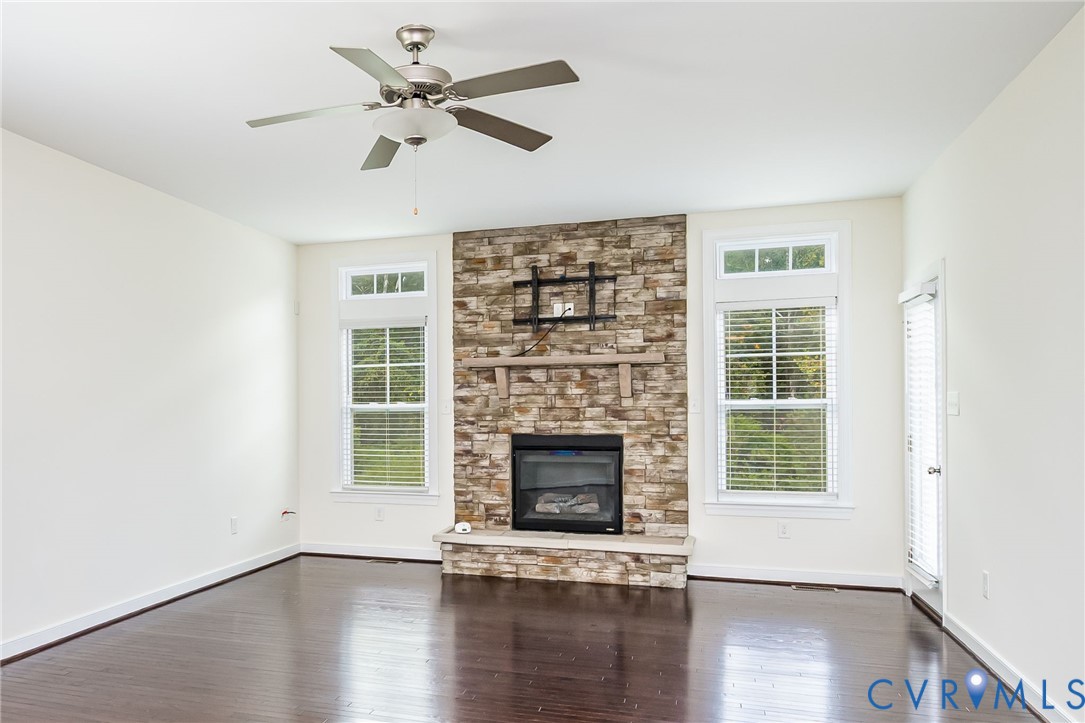11224 Hill Ridge Court Ashland, VA 23005 - Photo 12 of 35 a view of an empty room with wooden floor fireplace and a window