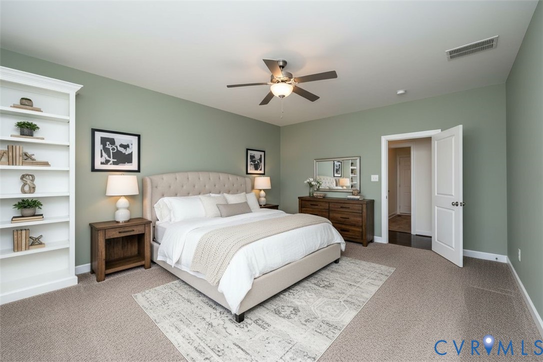 11224 Hill Ridge Court Ashland, VA 23005 - Photo 14 of 35 a spacious bedroom with a large bed and a chandelier