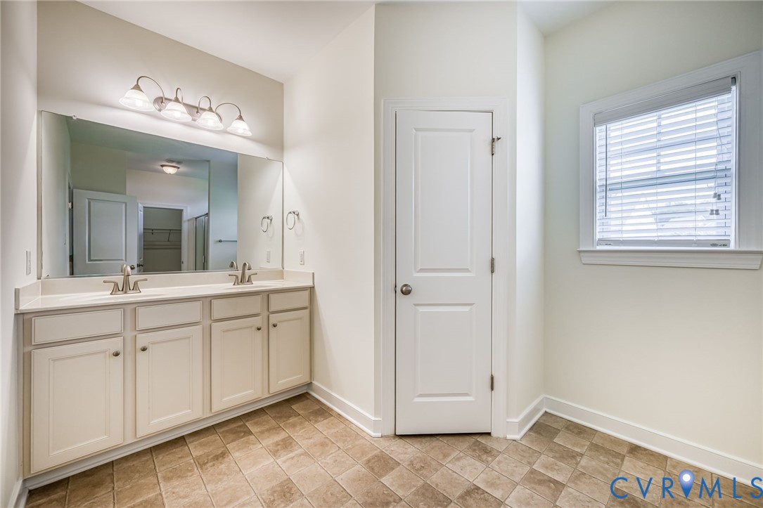 11224 Hill Ridge Court Ashland, VA 23005 - Photo 17 of 35 a spacious bathroom with a mirror and a sink