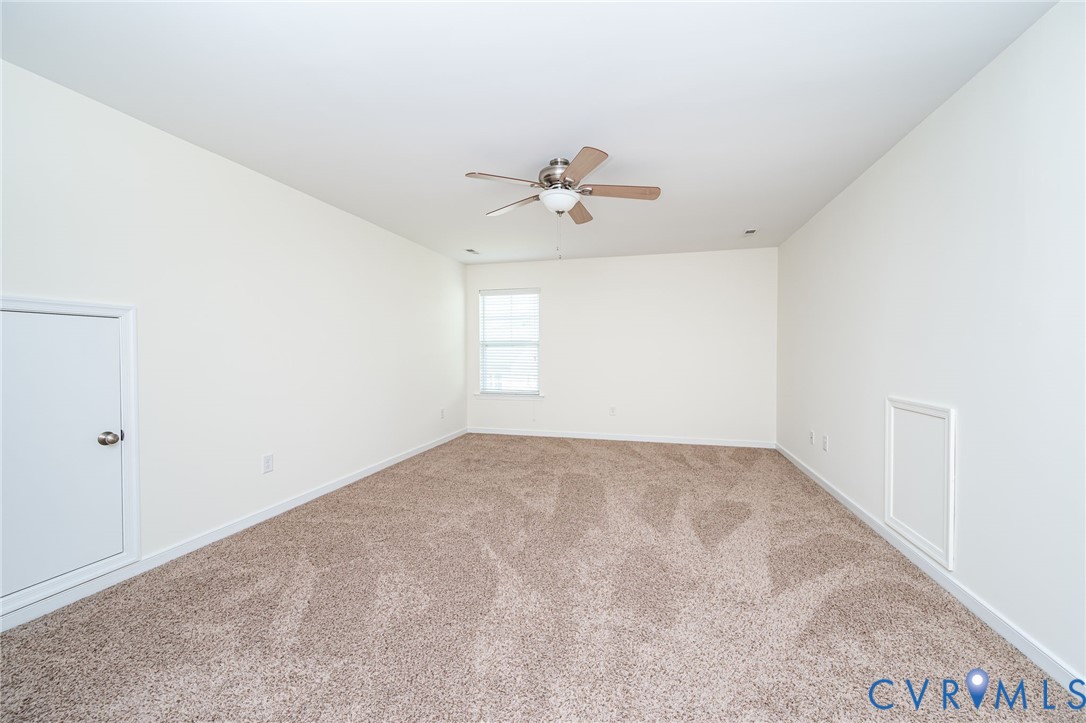 11224 Hill Ridge Court Ashland, VA 23005 - Photo 25 of 35 an empty room with windows and ceiling fan