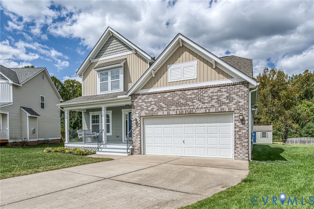 11224 Hill Ridge Court Ashland, VA 23005 - Photo 3 of 35 a front view of a house with a yard and garage