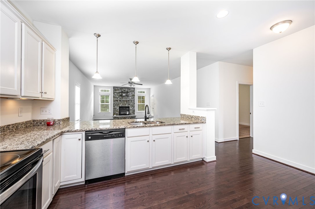 11224 Hill Ridge Court Ashland, VA 23005 - Photo 7 of 35 a kitchen with stainless steel appliances granite countertop a sink and stove top oven