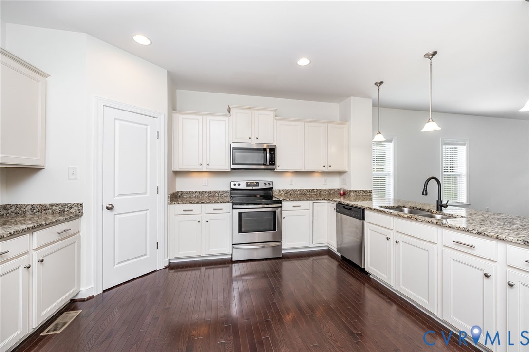 11224 Hill Ridge Court Ashland, VA 23005 - Photo 8 of 35 a kitchen with granite countertop white cabinets and white appliances