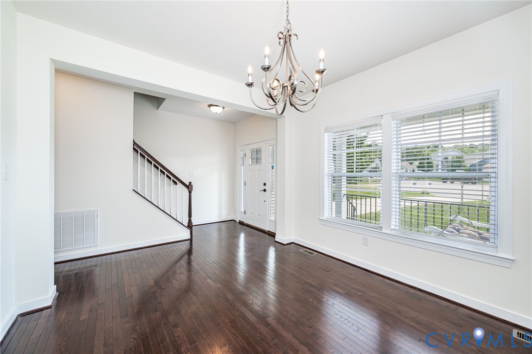 11224 Hill Ridge Court Ashland, VA 23005 - Photo 9 of 35 a view of an empty room with wooden floor and a window