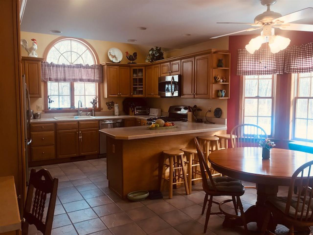 94 South Mountain Road Wallkill, NY 12589 - Photo 11 of 35 a kitchen with a table chairs sink and cabinets