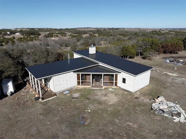an aerial view of a house with a yard