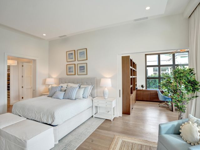 a bedroom with a bed and a large window