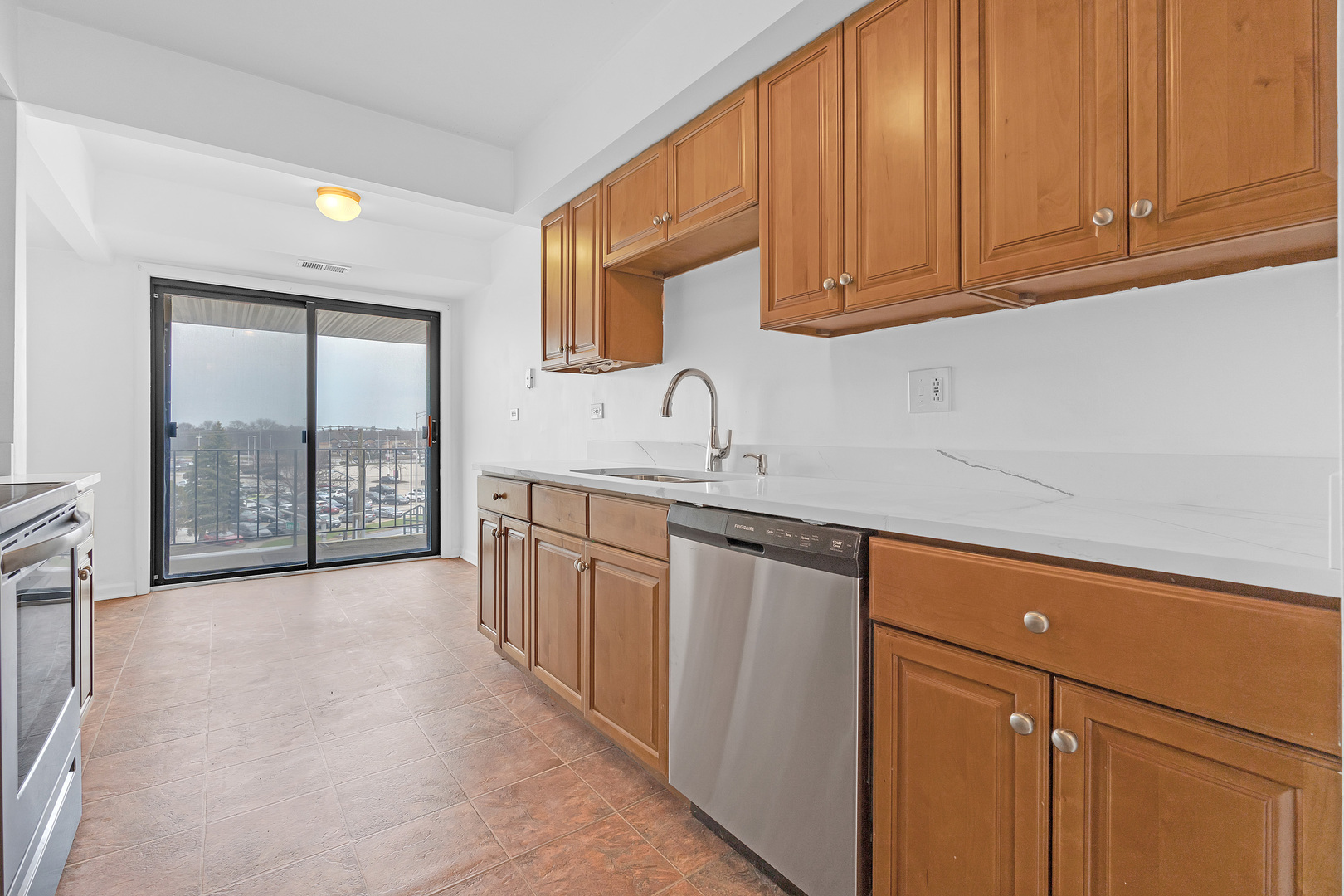 4901 Golf Road, Unit 410 Skokie, IL 60077 - Photo 11 of 26 a kitchen with stainless steel appliances granite countertop a sink stove and cabinets
