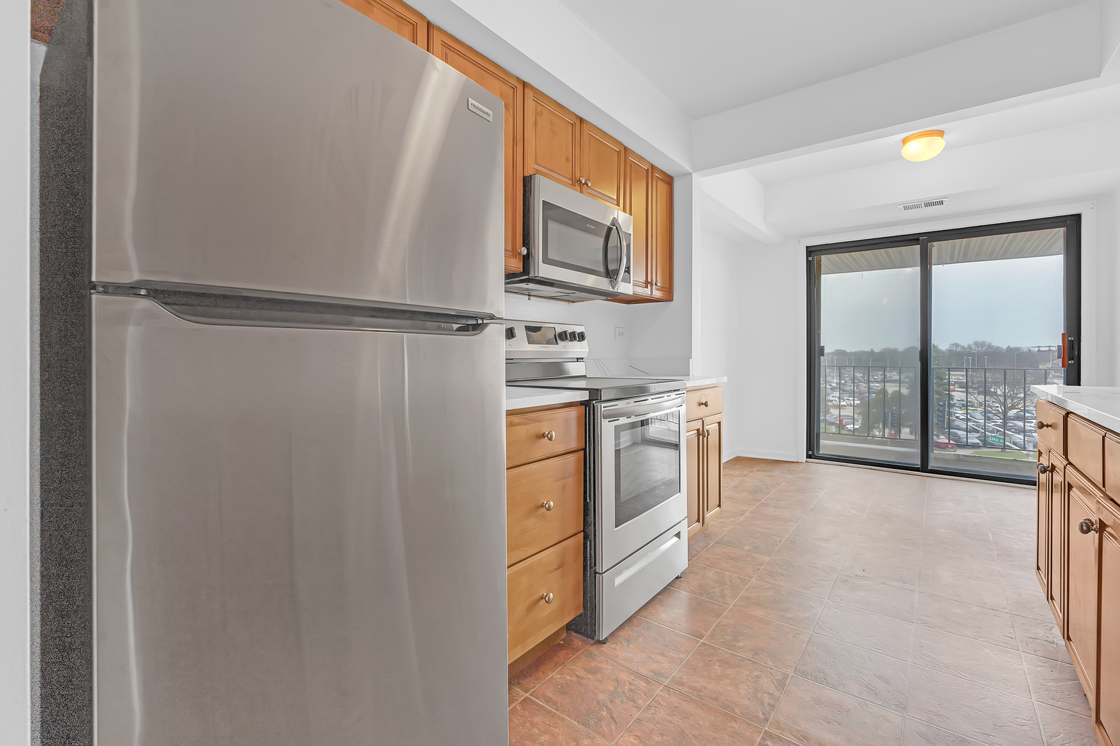 4901 Golf Road, Unit 410 Skokie, IL 60077 - Photo 13 of 26 a kitchen with white cabinets and white appliances
