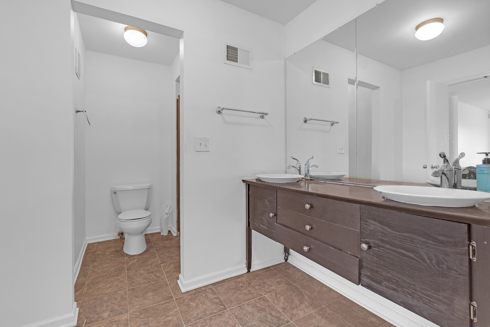 4901 Golf Road, Unit 410 Skokie, IL 60077 - Photo 18 of 26 a bathroom with a granite countertop double vanity sink a toilet and a mirror