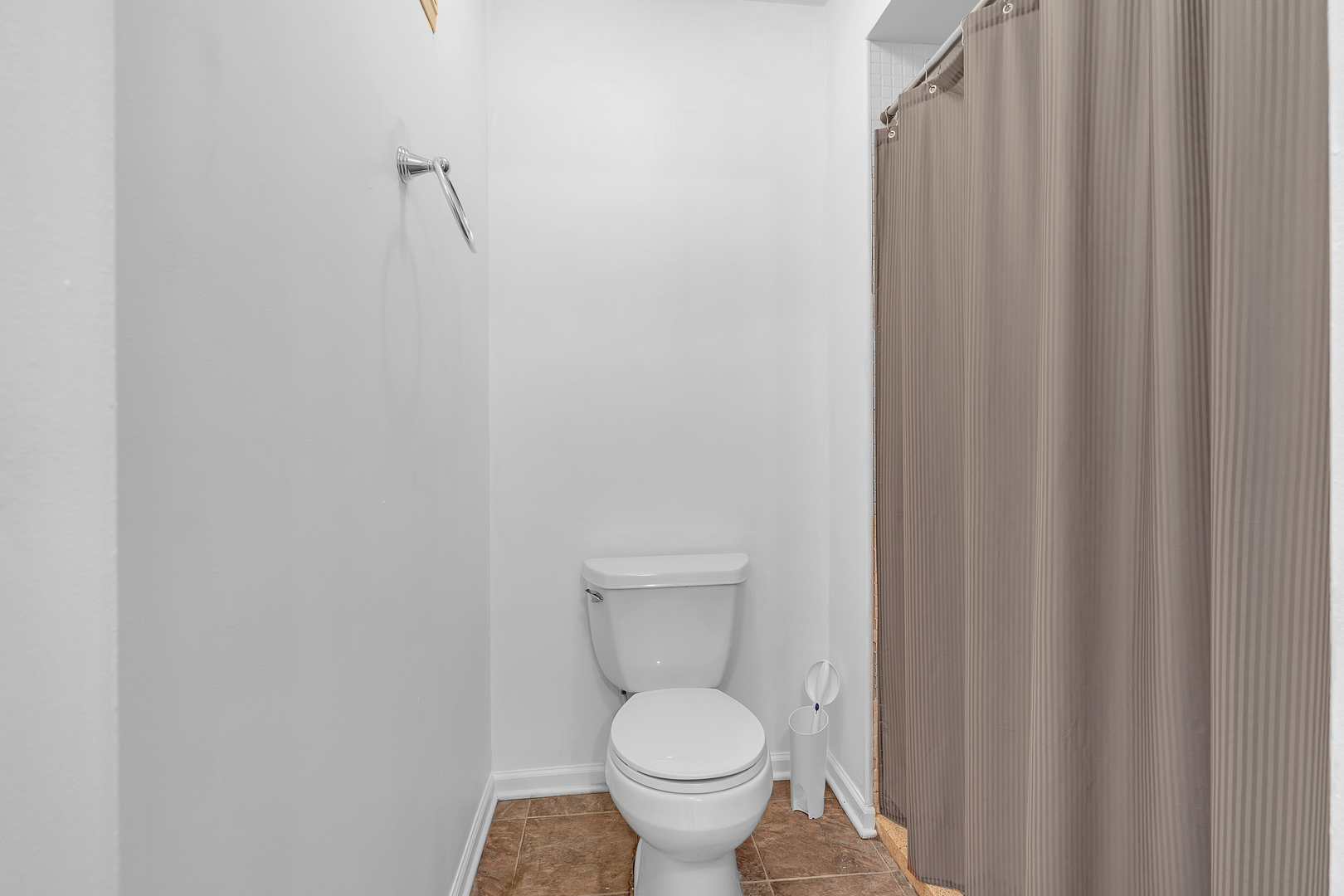 4901 Golf Road, Unit 410 Skokie, IL 60077 - Photo 19 of 26 a white toilet sitting next to a shower curtain