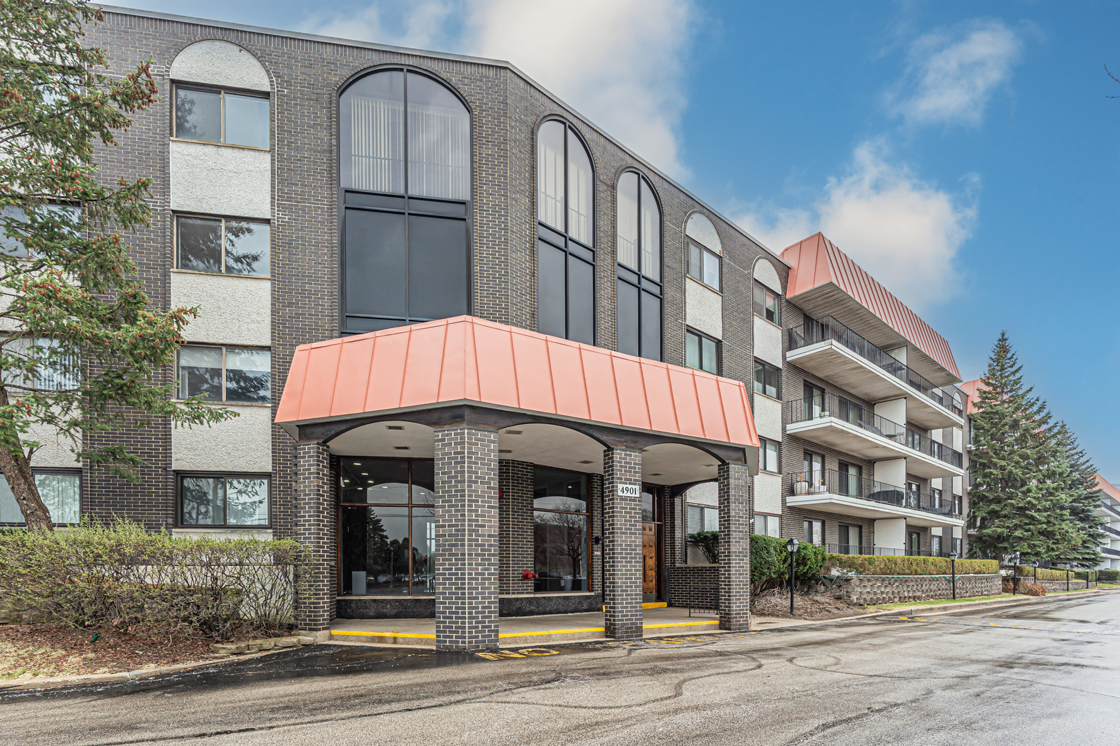 4901 Golf Road, Unit 410 Skokie, IL 60077 - Photo 2 of 26 a front view of a building and car parked