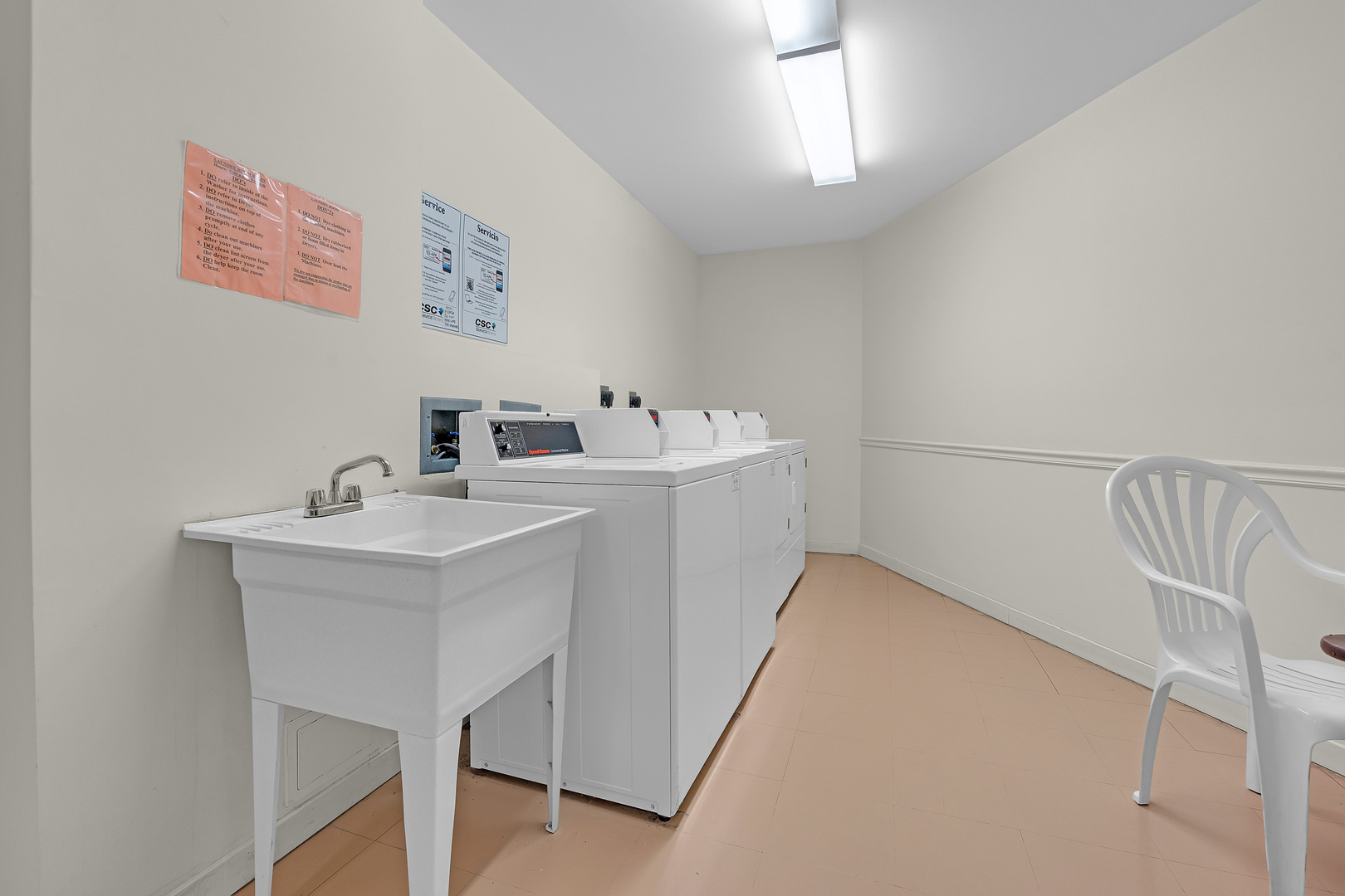 4901 Golf Road, Unit 410 Skokie, IL 60077 - Photo 24 of 26 a utility room with a sink dryer and washer