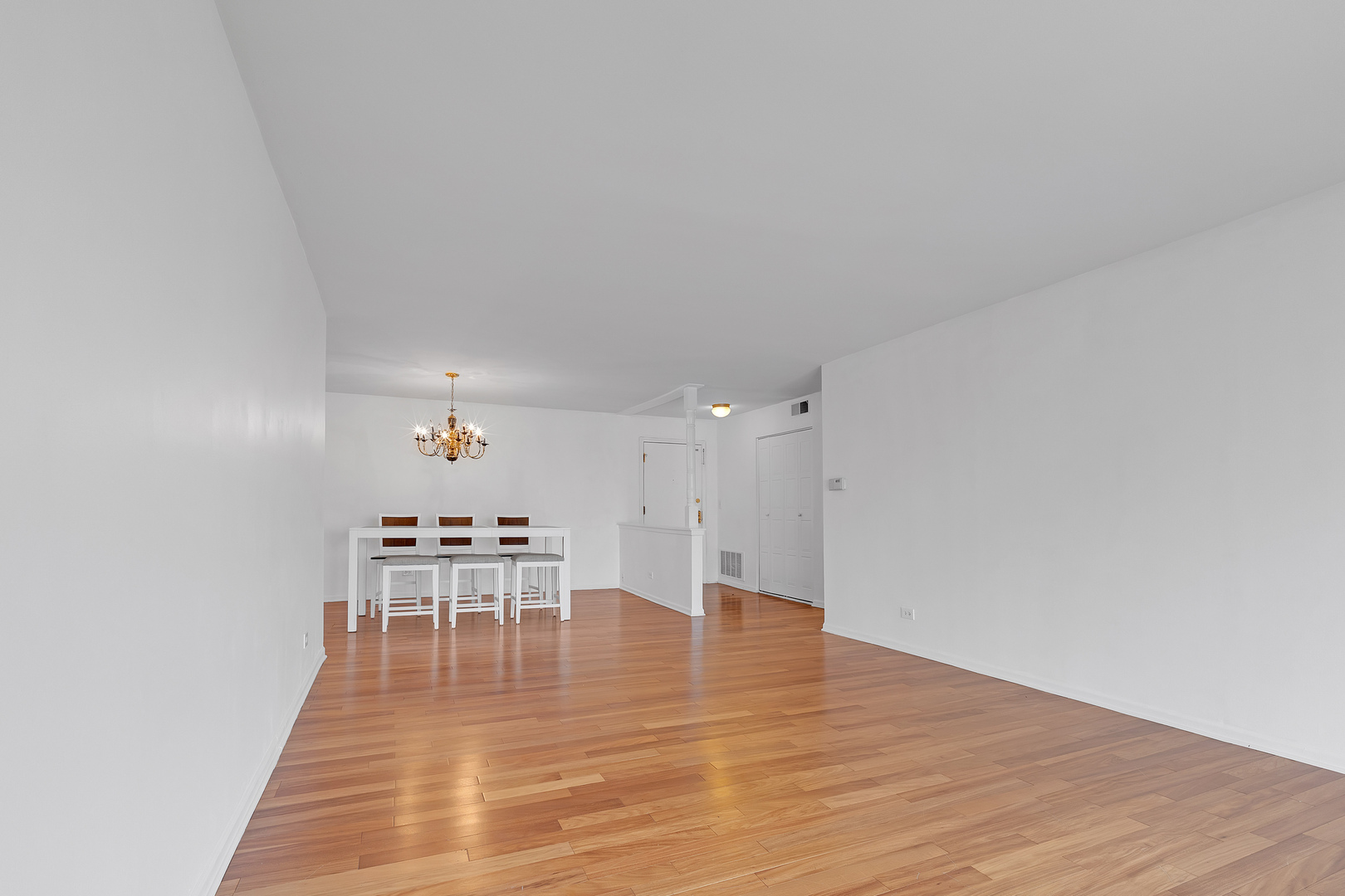 4901 Golf Road, Unit 410 Skokie, IL 60077 - Photo 7 of 26 a dining room with furniture and wooden floor