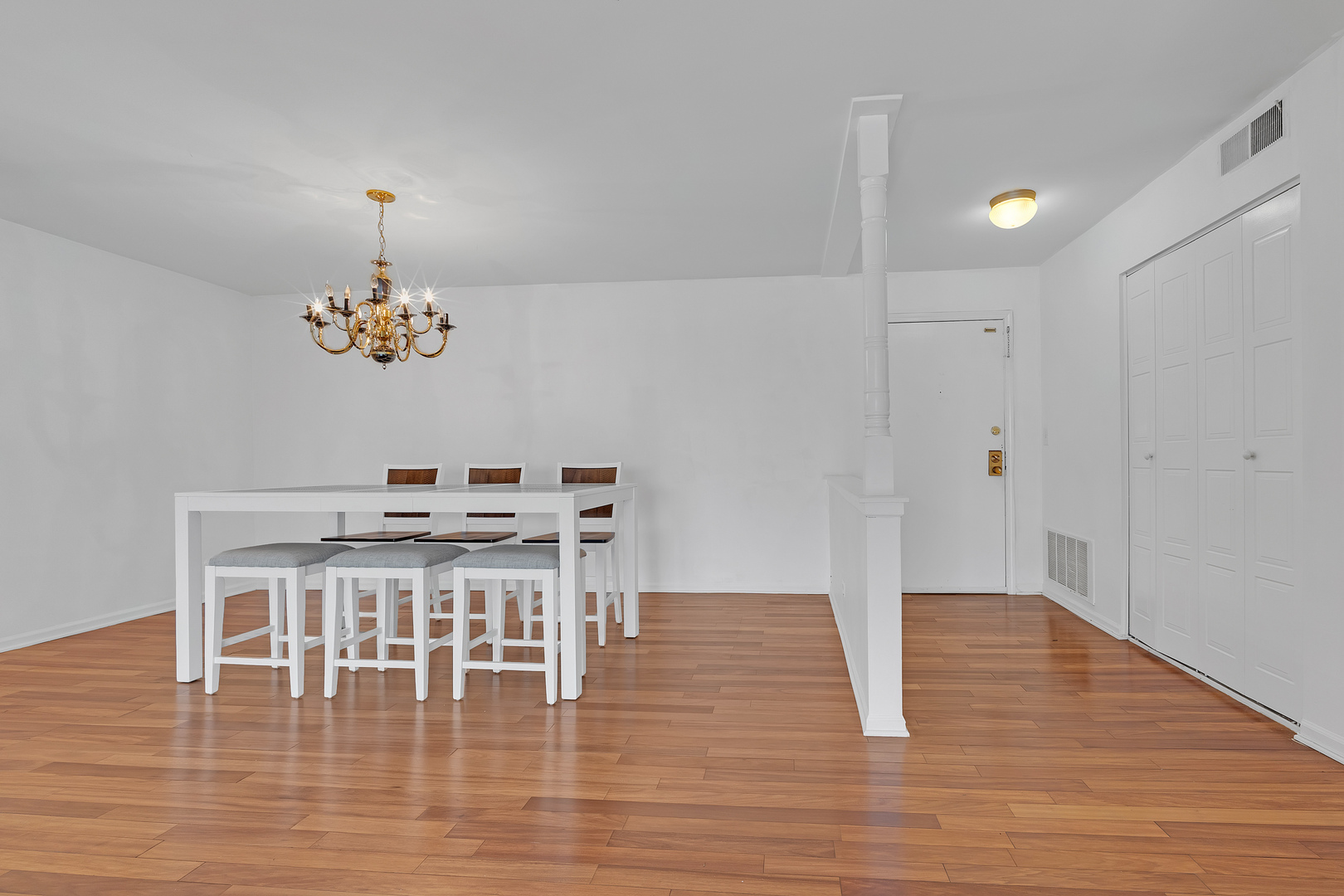 4901 Golf Road, Unit 410 Skokie, IL 60077 - Photo 8 of 26 a view of a dining room with furniture wooden floor and chandelier