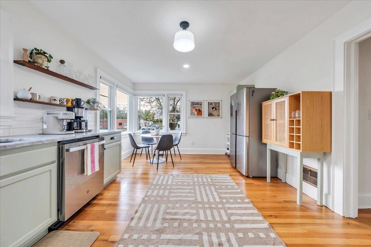5120 Starkey Road Roanoke, VA 24018 - Photo 13 of 43 a kitchen with stainless steel appliances granite countertop a stove a sink a dining table and chairs with wooden floor